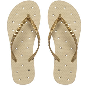 Image of shower flip flop featuring a Neutral sand-colored footbed with a metallic gold stud strap. Drainage hole pattern make for a perfect non-skid flip flop.